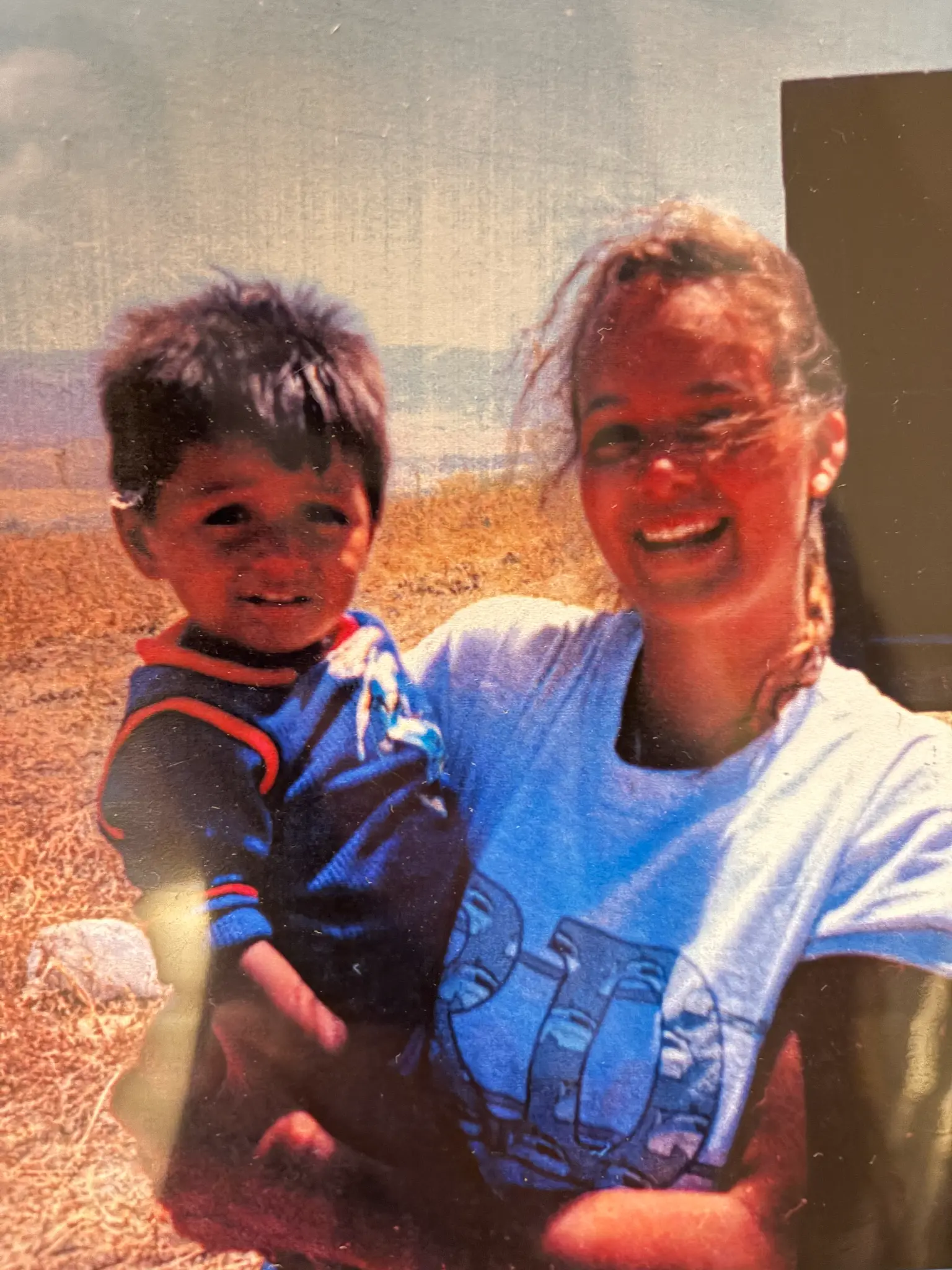 Julie on a service project with a young child.